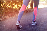 Athletic girl running in sportswear sneakers