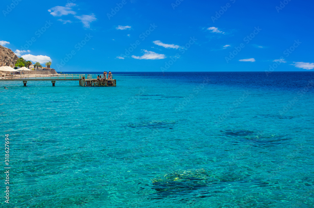 tropic summer time vacation coral beach reefs Indian ocean landscape beautiful vacation season destination in Tanzania coast line scenic view and relaxation people on jetty pier, copy space tropic summer time vacation coral beach reefs Indian ocean landscape beautiful vacation season destination in Tanzania coast line scenic view and relaxation people on jetty pier, copy space