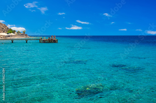 tropic summer time vacation coral beach reefs Indian ocean landscape beautiful vacation season destination in Tanzania coast line scenic view and relaxation people on jetty pier, copy space