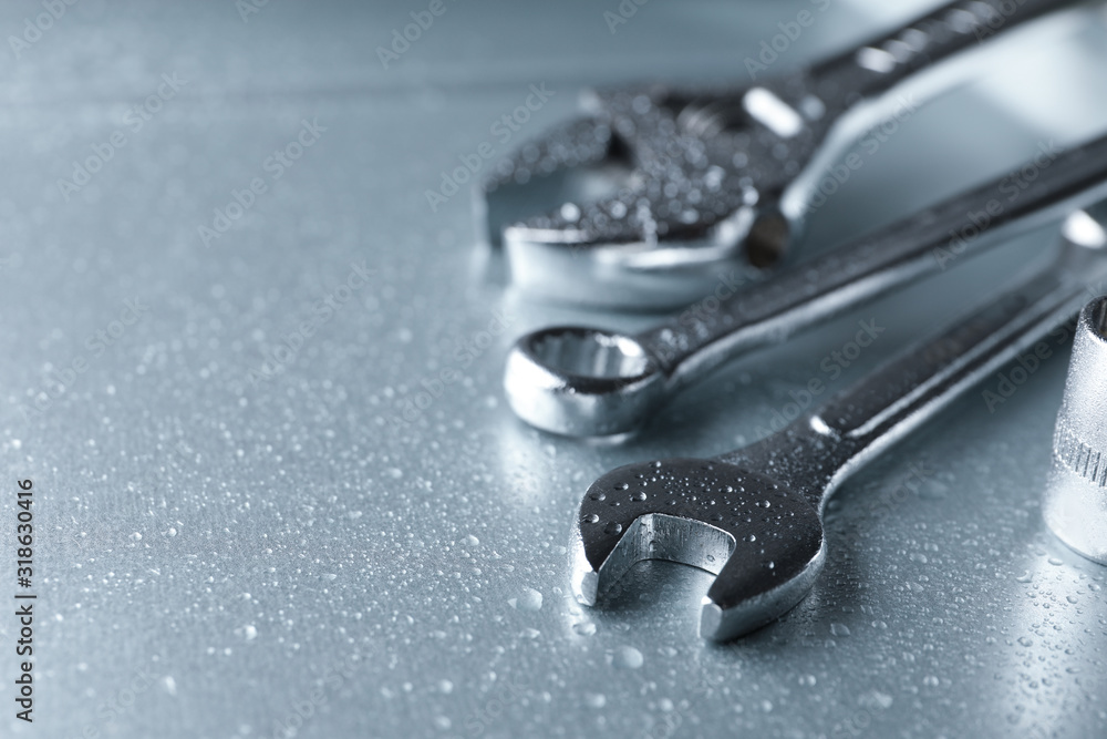 Auto mechanic's tools on metallic surface. Space for text Auto mechanic's tools on metallic surface. Space for text