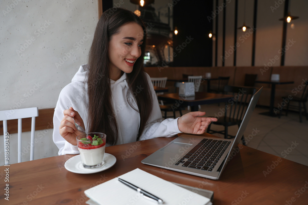 Young blogger working with laptop in cafe Young blogger working with laptop in cafe