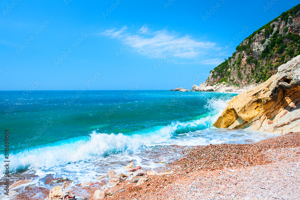 Beautiful beach with turquoise water and cliffs near Petrovac, Montenegro. Travel and vacation