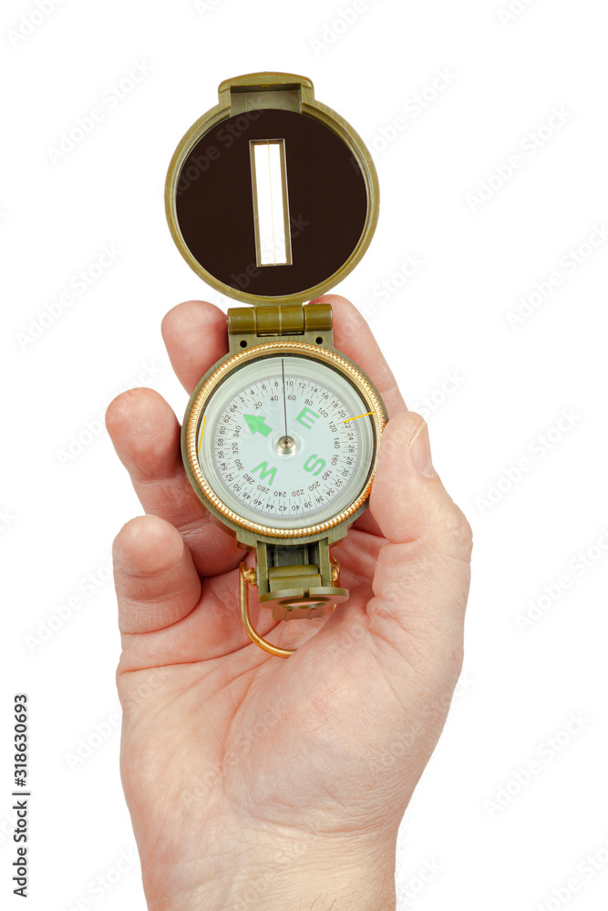 The hand holds the compass on a white background, isolate. The hand holds the compass on a white background, isolate.