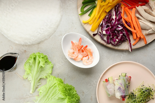 Dry rice paper and ingredients on light grey table, flat lay
