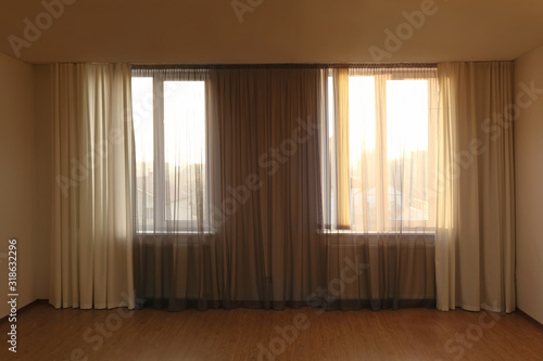 Windows with beautiful curtains in empty room
