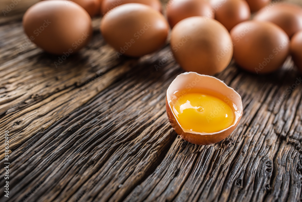 Fresh raw eggs on rustic wooden table Fresh raw eggs on rustic wooden table