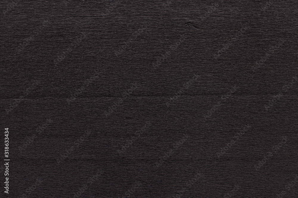 Texture of dark black corrugated thin uneven paper