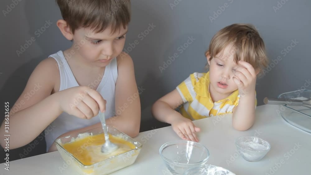 brother and sister knead the dough into pies. brother and sister knead the dough into pies.