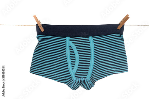 Underwear clothes (underpants) for baby boy hanging on the clothesline isolated on a white background