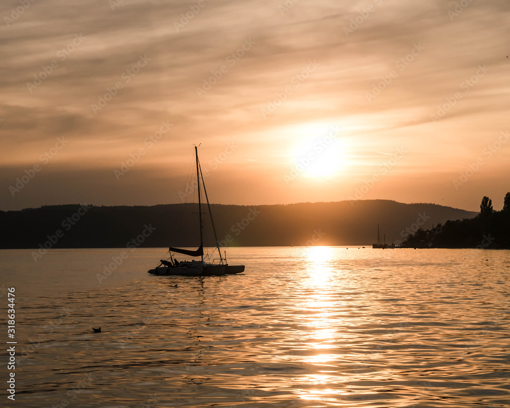 Sailboat on lake while sunset