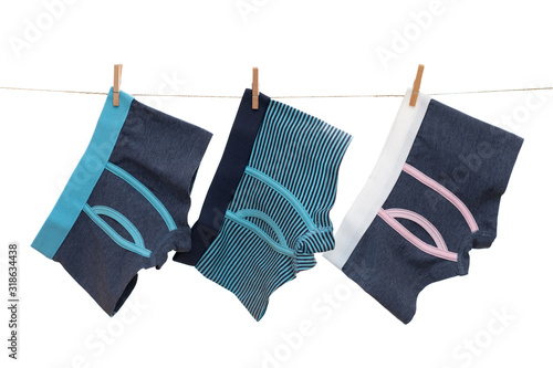 Underwear clothes (underpants) for baby boy hanging on the clothesline isolated on a white background