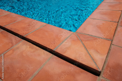 Swimming pool border and tiled terrace floor,  closeup of terracotta tiles photo