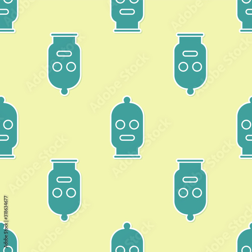 Green Balaclava icon isolated seamless pattern on yellow background. A piece of clothing for winter sports or a mask for a criminal or a thief. Vector Illustration