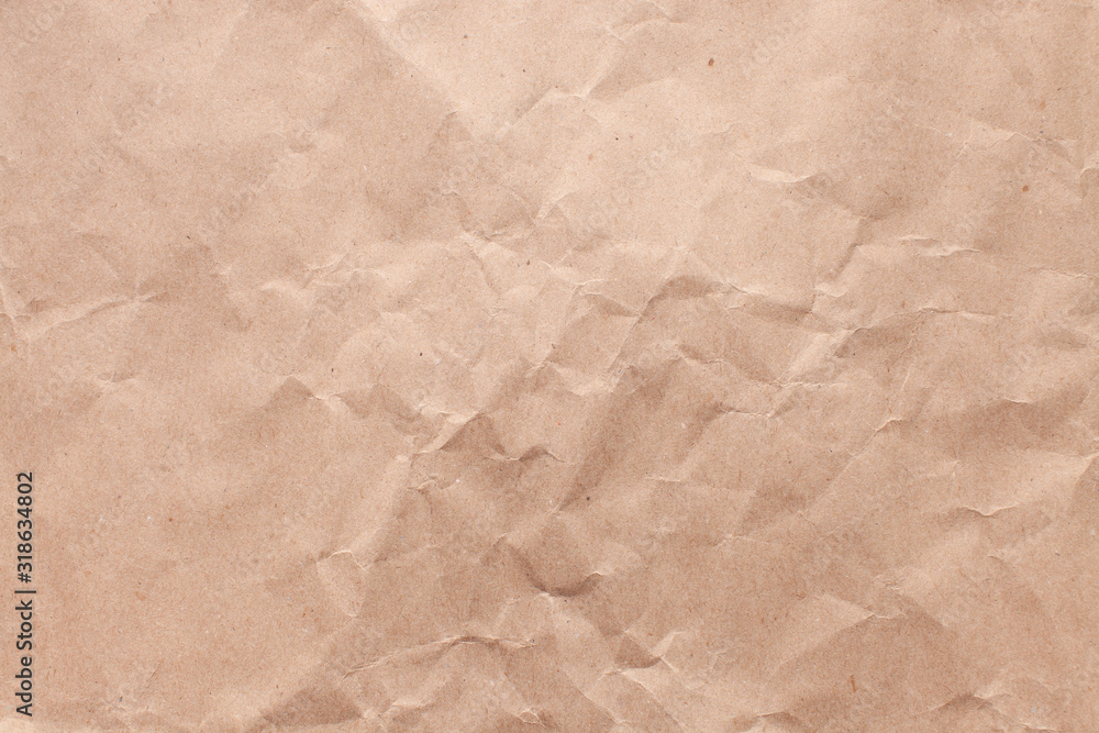 Obraz premium Texture of old rough recycled Kraft brown paper with creases