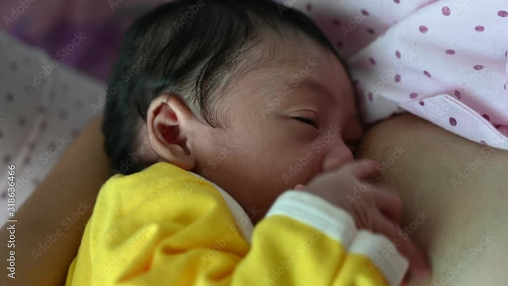 4K Asian woman breastfeeding newborn baby. Mother breastfeeding newborn