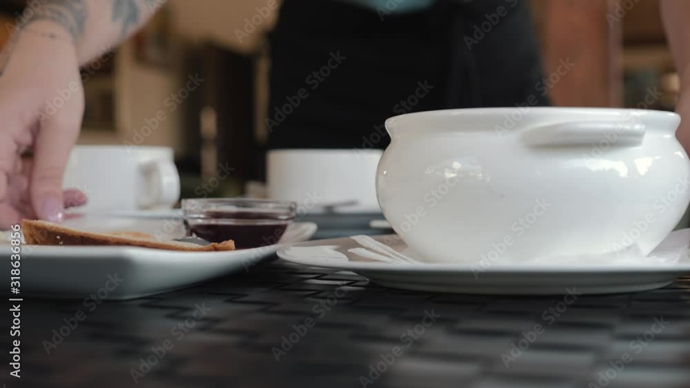The girl the waiter sets the table. Table setting close-up for lunch with white dishes. The girl the waiter sets the table. Table setting close-up for lunch with white dishes.