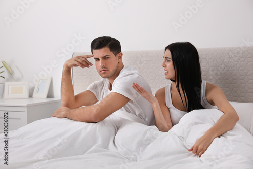 Couple with relationship problems quarreling in bedroom