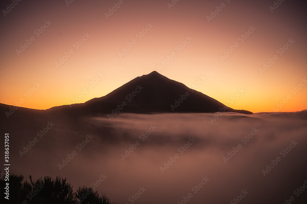 Beautiful view landscape of sunset or sunrise of el teide vulcan with clouds and foreground nature
