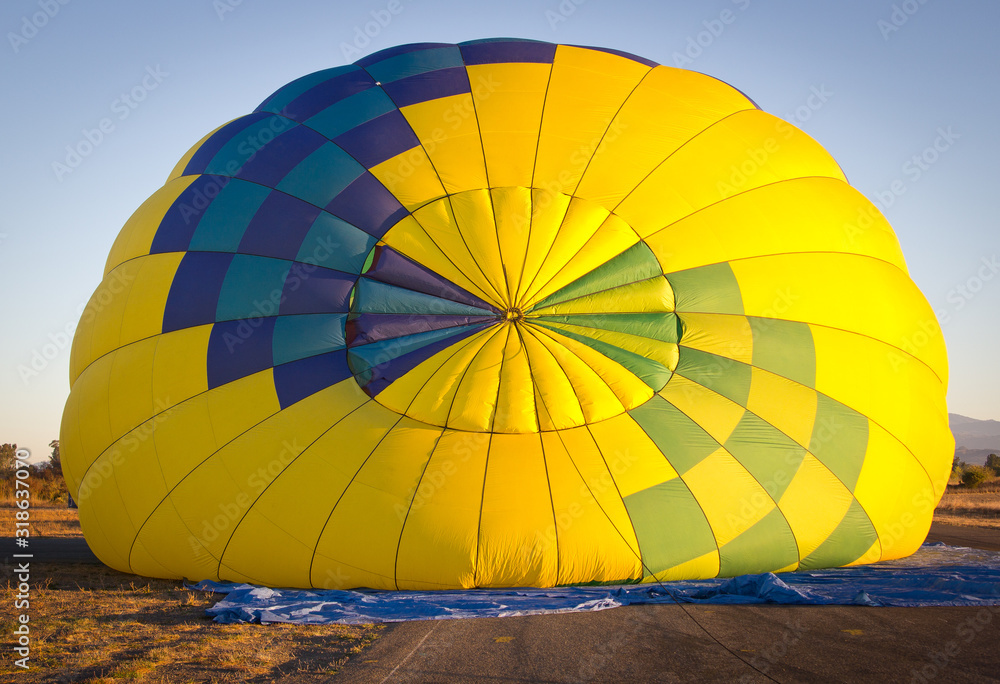Fototapeta premium Colorful hot air balloon view from the top during inflating. 