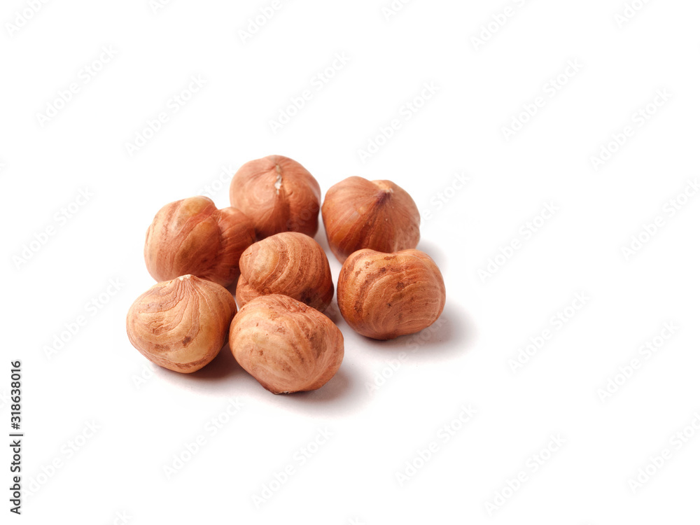Group of peeled hazelnut kernels, selective focus, isolate white background Group of peeled hazelnut kernels, selective focus, isolate white background