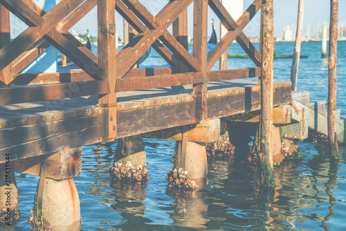 Old wooden pier embankment in the Grand Canal  Venice  Italy  retro toned.