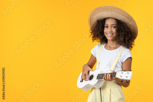 Little girl in hat playing ukulele isolated on white background photo