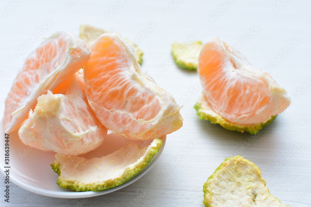 Natural, whole, chopped tangerines on wooden background Natural, whole, chopped tangerines on wooden background
