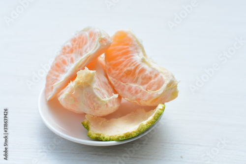  Natural, whole, chopped tangerines on wooden background