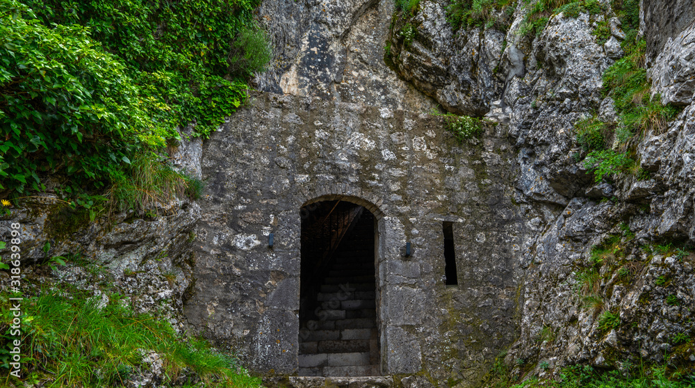 Exterior of the entrance to the citadel of Sisteron, rock fortress in the south of France, Europe. Listed as UNESCO World Heritage Site. Stone wall with traces of weathering and destruction.