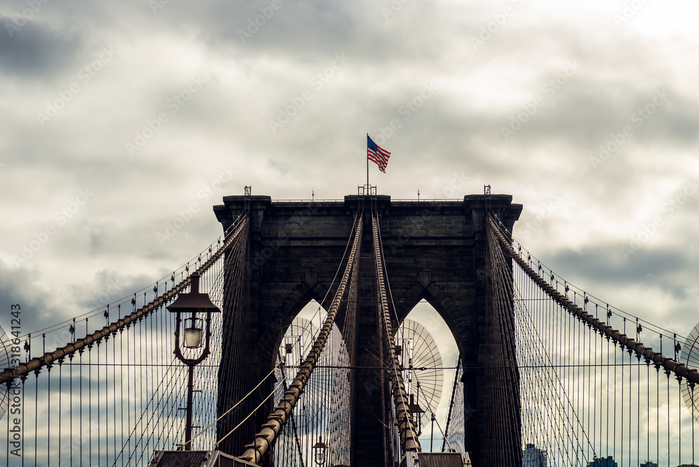 Obraz premium Details of the Brooklyn Bridge in New York City, USA. Toned image with sun light leak