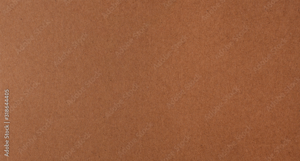 Fototapeta premium Texture of brown recycled corrugated cardboard with small inclusions