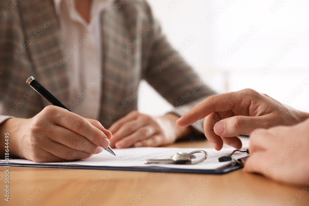 Fototapeta premium Real estate agent working with client in office, closeup