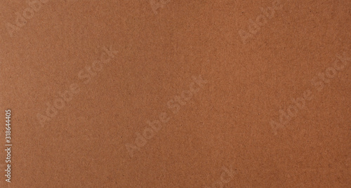 Texture of brown recycled corrugated cardboard with small inclusions