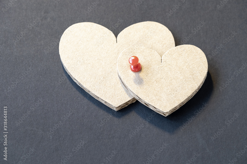 Fototapeta premium Valentine's day cardboard hearts on a dark background