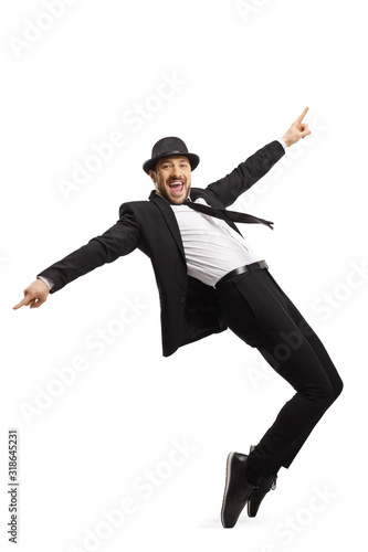 Smiling guy in a suit dancing and pointing with fingers