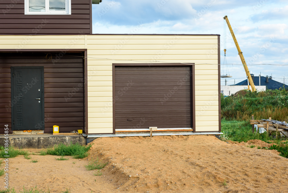 Garage door in residential house of siding. Garage door in residential house of siding.