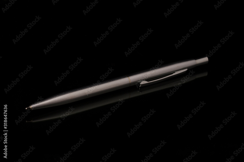 Silver metal pen on black background Silver metal pen on black background