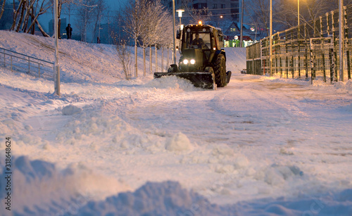 Clearing snow from the road.