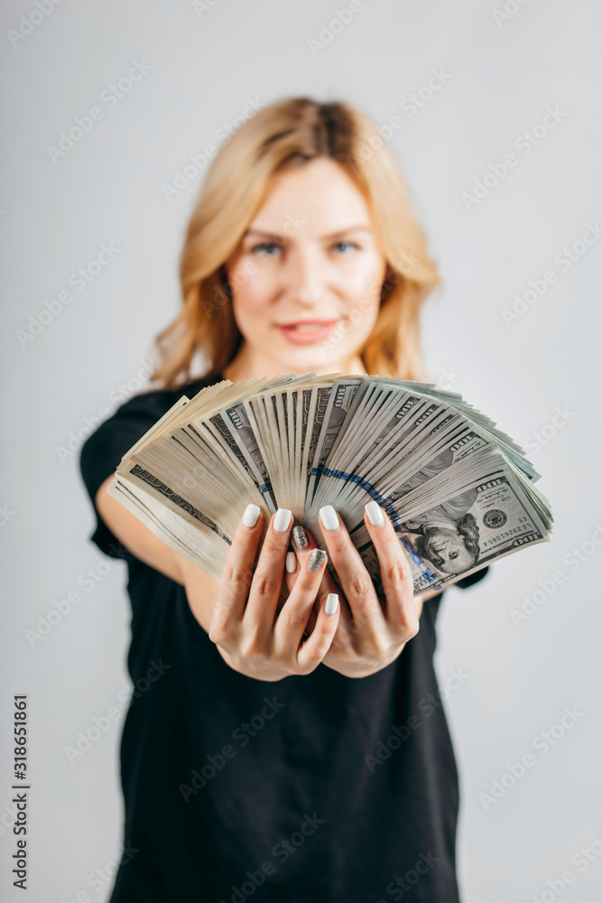 Woman showing money real dollars on white background Woman showing money real dollars on white background