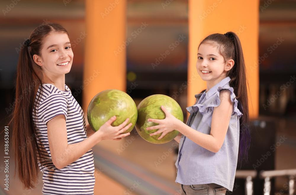 Fototapeta premium Happy girls with balls in bowling club