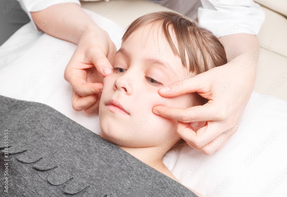Girl receiving osteopathic treatment of her face Girl receiving osteopathic treatment of her face