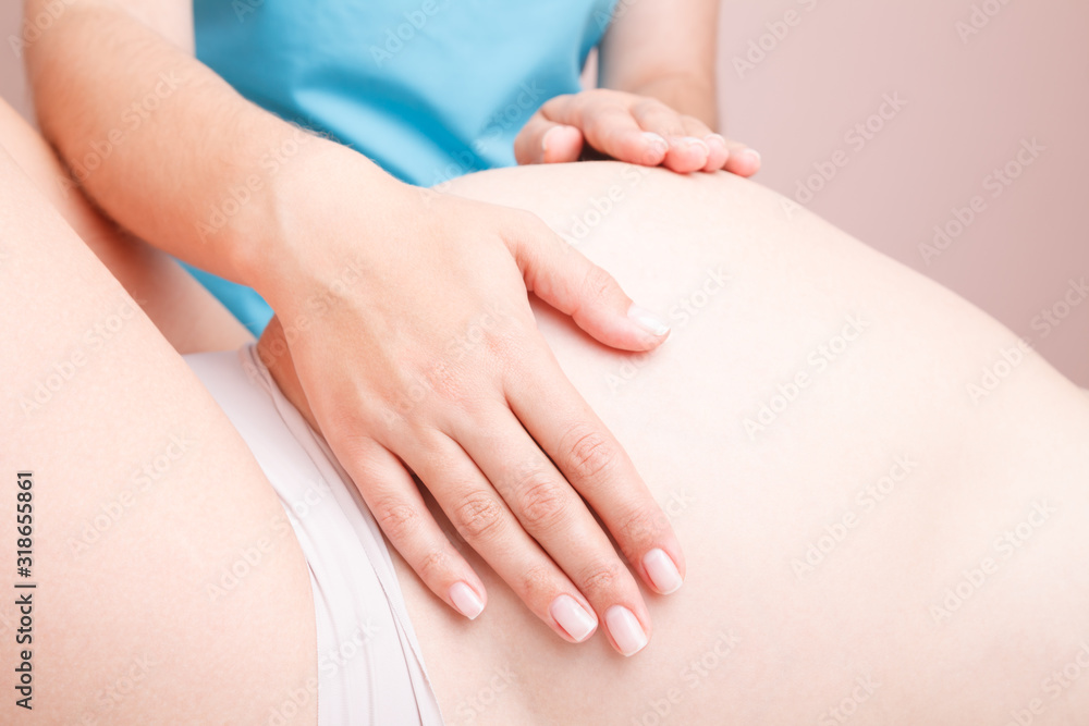Pregnant woman receiving osteopathic treatment of her belly