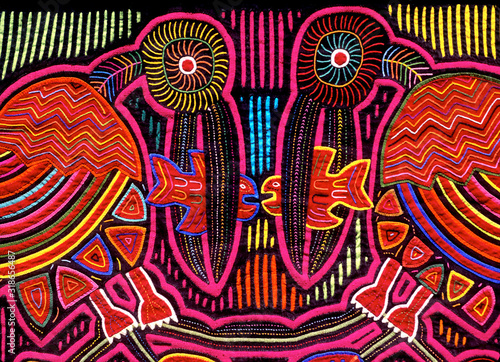 Cuna Mola panel with pelican and fish motif, using the reverse appliqué technique to expose colorful underling layers, San Blas Islands, Panama photo