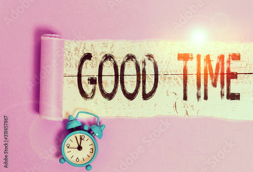 Word writing text Good Time. Business photo showcasing the right moment to do something or for something to happen Alarm clock and torn cardboard placed above a wooden classic table backdrop photo