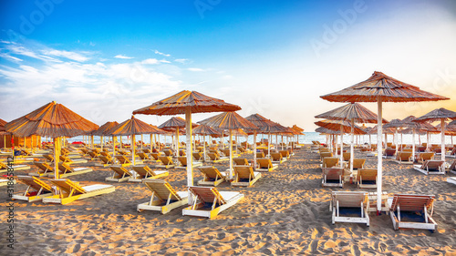 Sun umbrellas and deckchairs on the Copacabana beach, part of Great Beach (Velika Plaza) in Ulcinj photo