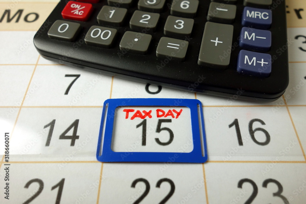 Calendar on office desk showing tax day for filling - April 15 2020 Calendar on office desk showing tax day for filling - April 15 2020