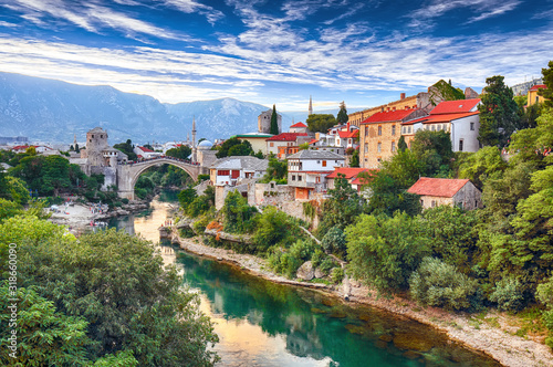 Schilderij op canvas Fantastic Skyline of Mostar with the Mostar Bridge, houses and minarets, during sunny day
