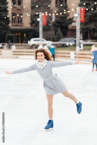 Beautiful curly girl riding in the skate rink