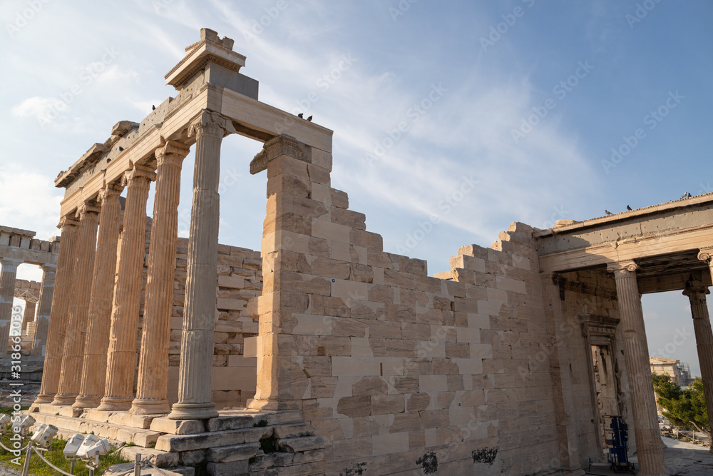 Ancient Erechtheion temple on Acropolis hill in Athens, Greece with pillars and statues, soft focus.