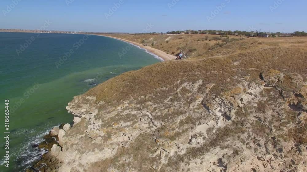 People enjoying view of sea coast People enjoying view of sea coast